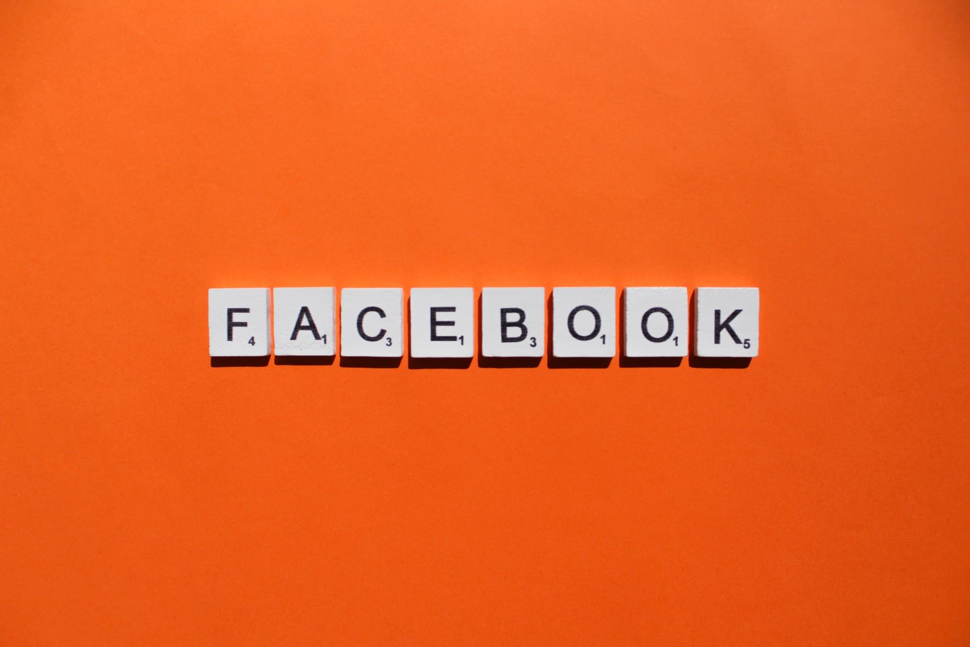 Facebook scrabble letters word on a orange background